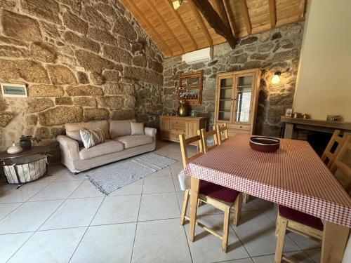 a living room with a table and a couch at Serena Nest 01 in Rio Douro