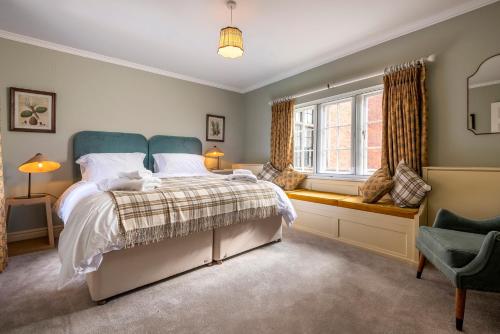 a bedroom with a bed and a window at West House in High Legh