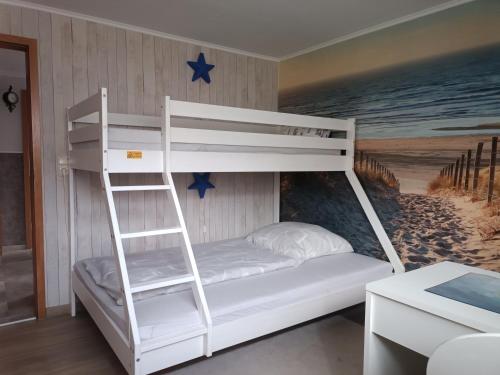 a bunk bed with a ladder in a room at Ferienwohnung Ankerplatz Züssow in Züssow