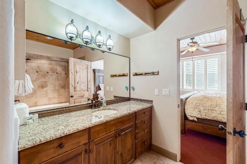 a bathroom with a sink and a large mirror at Steps to Brian Head Resort: Ski Home w/ Games in Brian Head