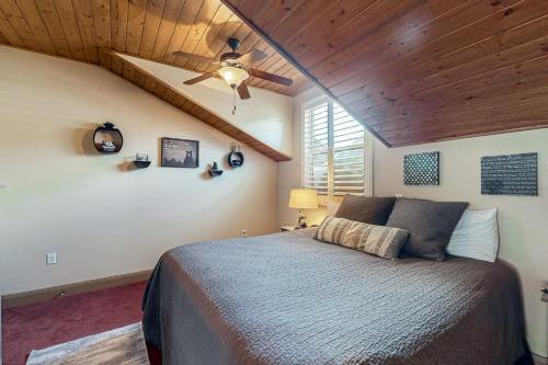 a bedroom with a bed and a ceiling fan at Steps to Brian Head Resort: Ski Home w/ Games in Brian Head