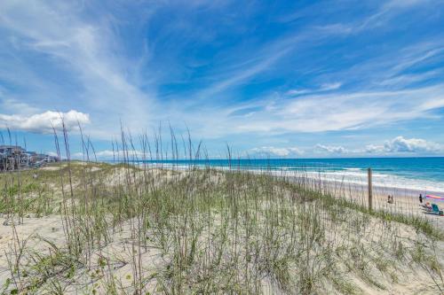 a beach with tall grass and the ocean at 7916 - Hatteras Vista in Hatteras
