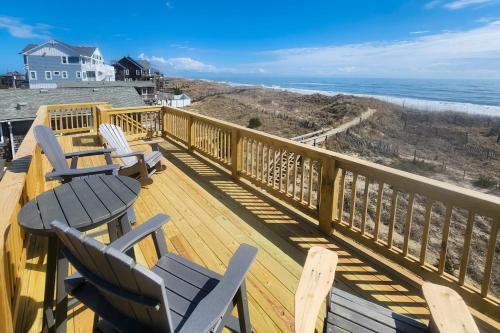 a deck with chairs and a view of the beach at 7916 - Hatteras Vista in Hatteras