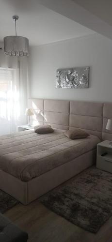 a bedroom with a bed and a table with a lamp at Casa da Gena in Nazaré