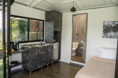 a bathroom with a sink and a toilet in a room at Rocks Glamping - Guatapé, El Peñol in El Peñol