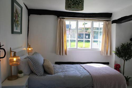 a bedroom with a bed and a window at The Elm, Abbots Ripton in Abbots Ripton