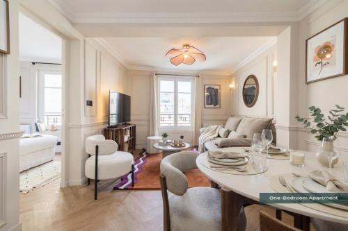 a living room with a table and a couch at PoeticStay - Neuilly sur Seine - Dulud in Neuilly-sur-Seine