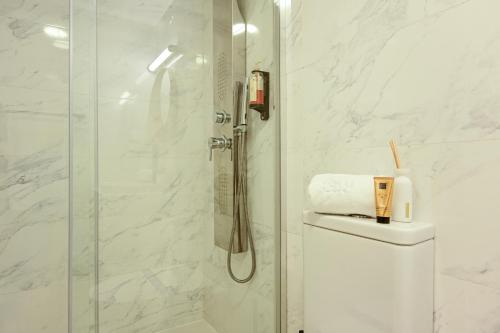 a white bathroom with a shower and a toilet at ON Apartments - MA62 Downtown in Porto