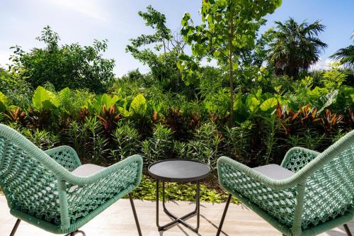 two chairs and a table on a patio at Hilton Tulum Riviera Maya All-Inclusive Resort in Tulum