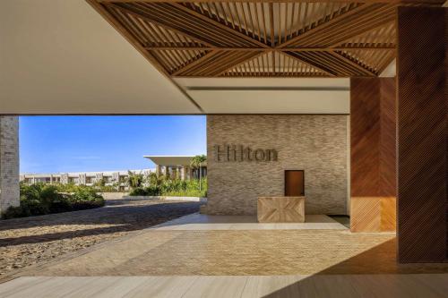 a lobby with a hilton sign on the side of a building at Hilton Tulum Riviera Maya All-Inclusive Resort in Tulum