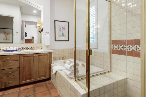 a bathroom with a shower and a toilet and a sink at La Quinta Resort & Club in La Quinta