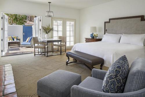 a bedroom with a bed and a table and chairs at La Quinta Resort & Club in La Quinta