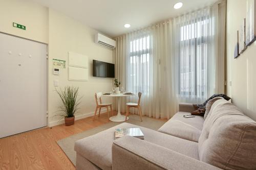 a living room with a couch and a table at ON Apartments - MA62 Downtown in Porto
