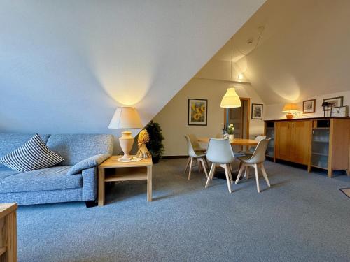 a living room with a couch and a table at Oewern Diek App 09 in Wustrow