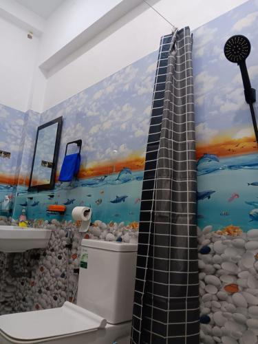 a bathroom with a painting of the ocean at Sanda Villa Dodanduwa in Dodanduwa