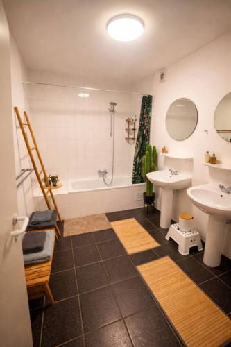 a bathroom with a sink and a tub and a toilet at Peace&Loft in Durbuy Old in Durbuy
