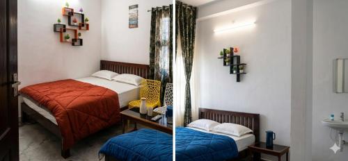 a bedroom with two beds and a sink in a room at Elite Castle Stay in Kottakupam