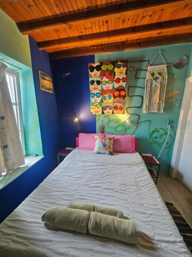 a bedroom with a large bed with a blue wall at LaLaLand in Mikonos