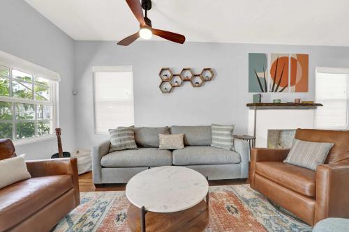 a living room with a couch and a table at 2 Cottages Downtown Lake Worth - Private Pool in Lake Worth