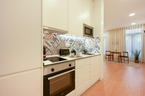 a kitchen with a sink and a stove top oven at ON Apartments - MA62 Downtown in Porto