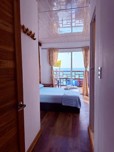 a bedroom with a bed and a view of the ocean at Roma beach in Cartagena de Indias