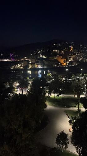 a view of a city at night with lights at Casa Giardino Vista Mare in Ventimiglia