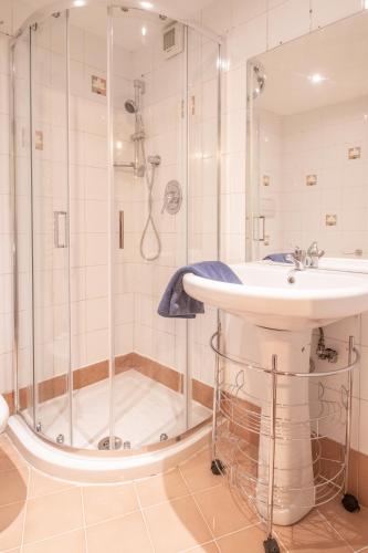 a bathroom with a sink and a shower at Long John Apartment in Rome