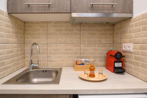 a kitchen counter top with a sink and a sink at Louros rooms in Koufonisia