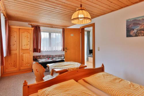 a bedroom with a bed and a living room at Bergapartments Wötzinger in Berwang