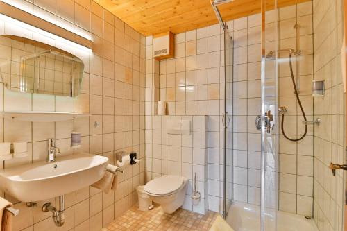 a bathroom with a sink toilet and a shower at Bergapartments Wötzinger in Berwang