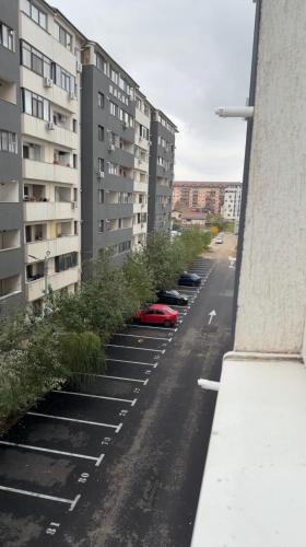 an empty street with parked cars and buildings at Julia Militari Studio in Roşu