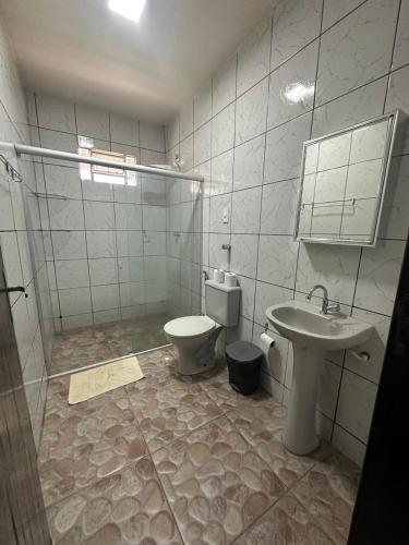 a bathroom with a toilet and a sink at Chácara Betel in Marechal Deodoro