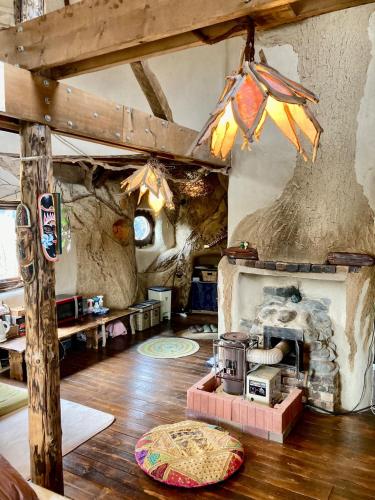 a living room with a stove and a fireplace at Tida House - Vacation STAY 07404v in Koshimizu-shigai