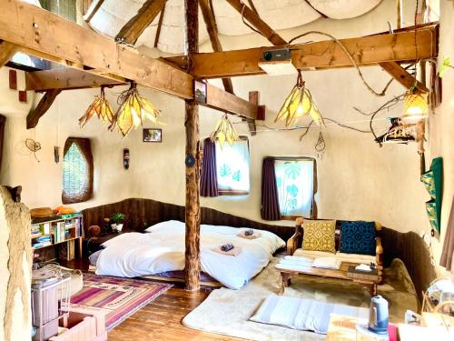 a bedroom with a bed and a couch in it at Tida House - Vacation STAY 07404v in Koshimizu-shigai