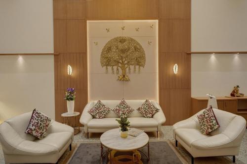 a living room with two couches and a table at Rajpath Beacon Hotel Belagavi in Belgaum