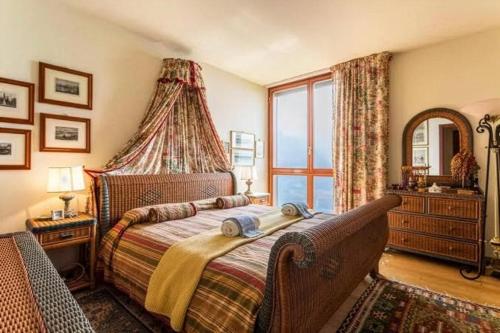 a bedroom with a bed and a large window at Villa Bellavista Lakeview Pool in Civenna