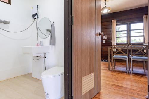 a bathroom with a toilet and a sink at PATTA Hideaway Chiang Dao in Chiang Dao