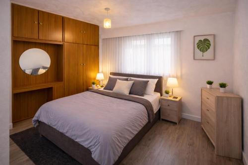 a bedroom with a large bed and two lamps at EMGS property ltd in Liverpool