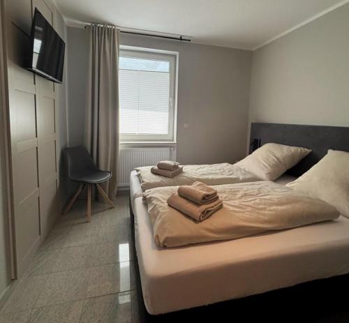 a bedroom with two beds with towels on them at Upland-Living in Willingen