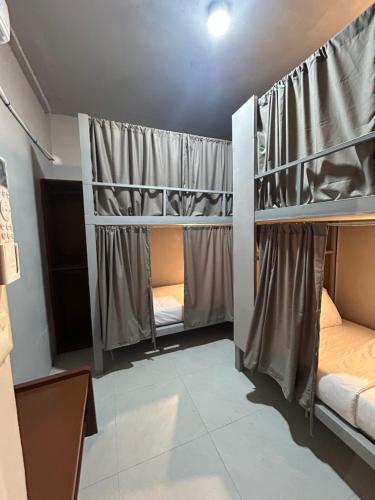 a room with three bunk beds in it at Sleep Squad Hostel in El Nido