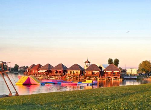 a group of houses on a river with boats at Domček na vode 5 in Senec