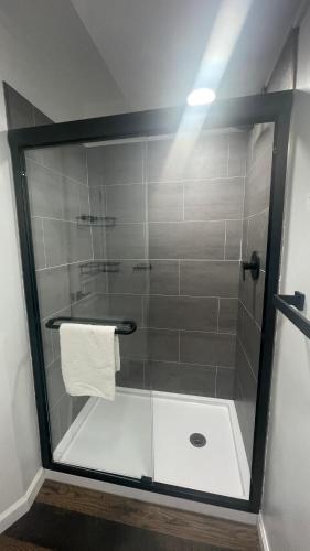 a shower with a glass door in a bathroom at Basswood Resort in Platte City