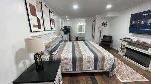 a bedroom with a large bed and a tv at Basswood Resort in Platte City
