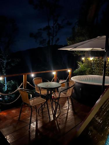 a patio with a table and chairs and a bath tub at Glamping Villa JuanMa in Salónica