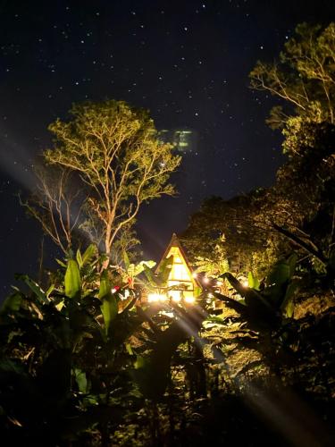 a cabin in the woods at night at Glamping Villa JuanMa in Salónica