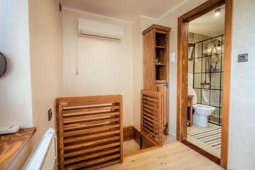 a bathroom with a tub and a toilet and a mirror at Forest by Leni - National Park Salt Pool Villa in Beočin