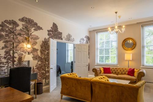 a living room with a couch and a table at St Michael's Manor Hotel - St Albans in St. Albans