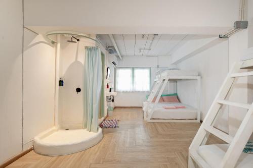 a room with two bunk beds and a wooden floor at Green Group Hotel & Pool Bangkok Old Town in Bangkok