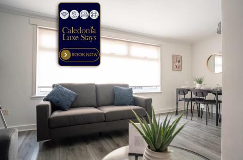 a living room with a couch and a table at Torbrex House in Cumbernauld