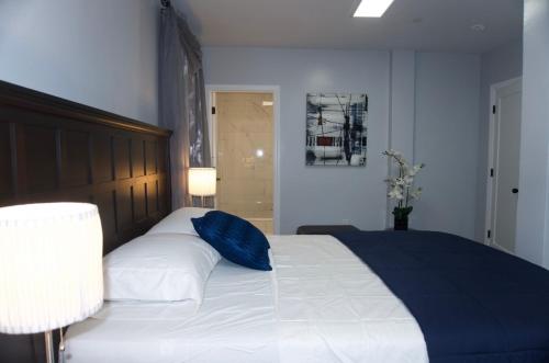 a bedroom with a large bed with a blue pillow at Master room w private bathroom 23 in Guttenberg